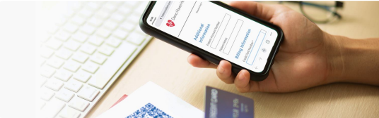 A patient goes to pay their bill online by scanning the QR code with their smartphone.