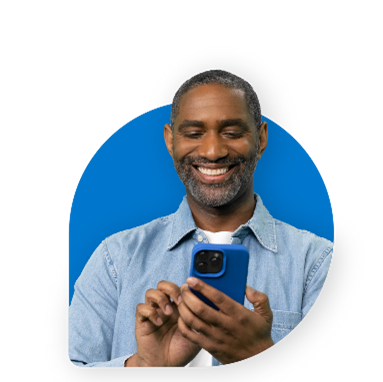 A person is holding and looking at a phone.