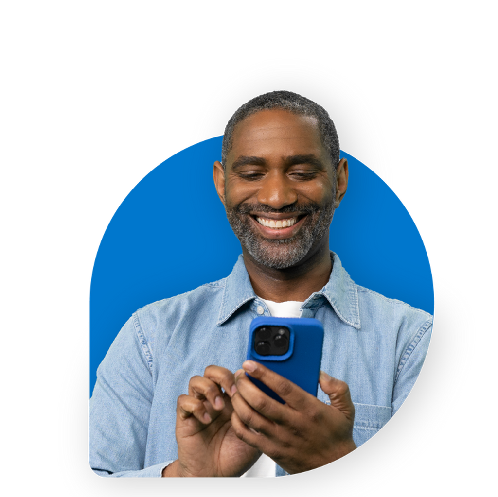 An adult is staring at the phone in their hand.